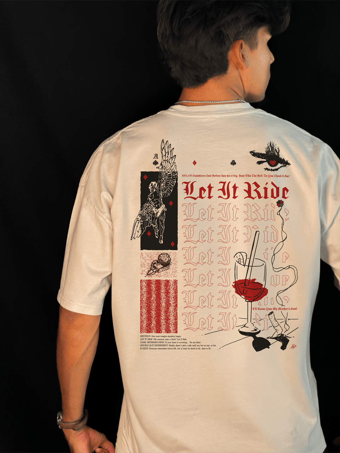 Back of the Let It Ride oversized tee in bone, worn, with red Let It Ride lettering, a winged Icarus, a burning eye and a small printed legend