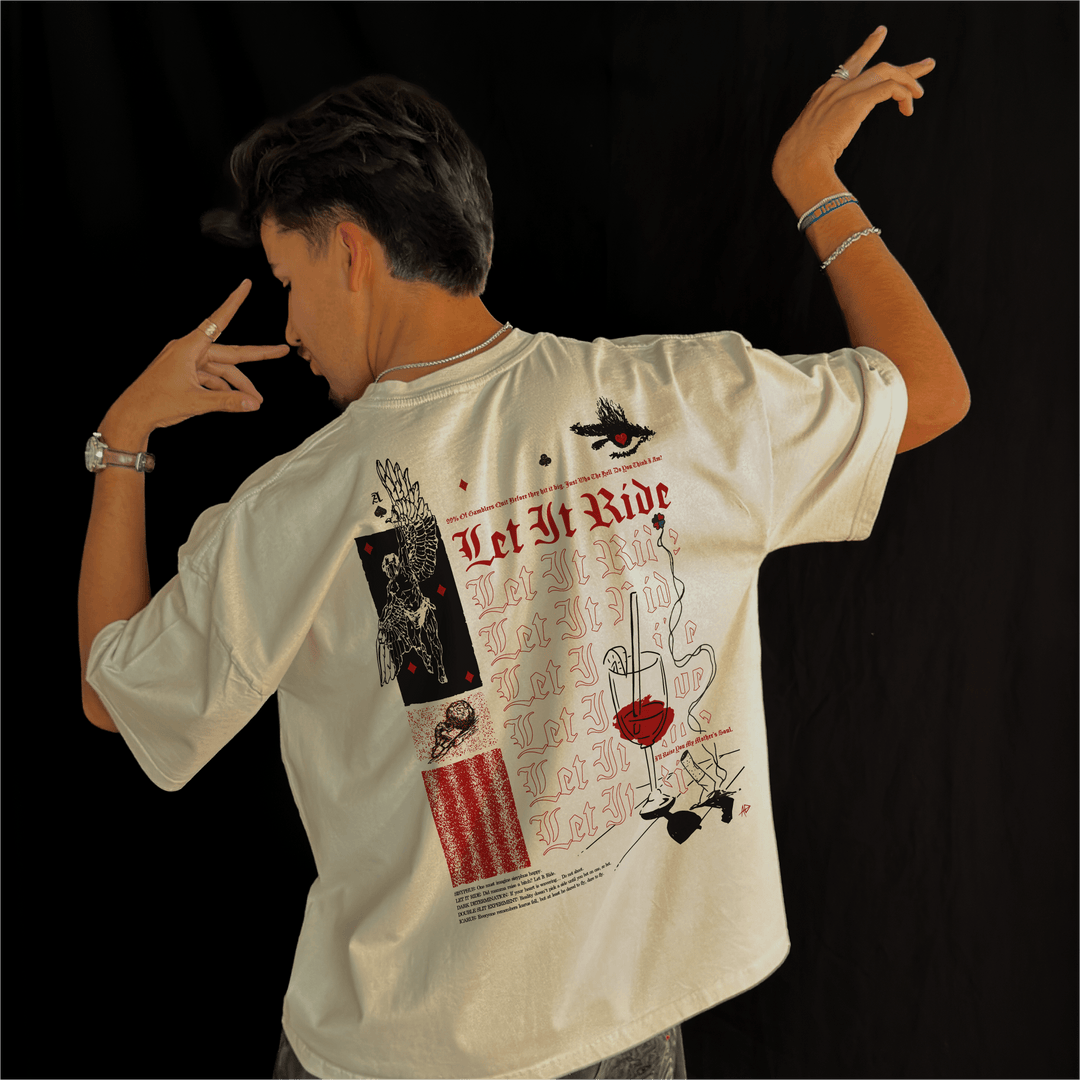 Man wearing the Let It Ride oversized tee in bone, seen from the back with one arm raised