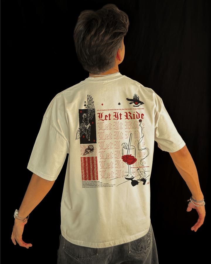 Man wearing the Let It Ride oversized tee in bone, seen from the back with arms out, showing the boxy fit